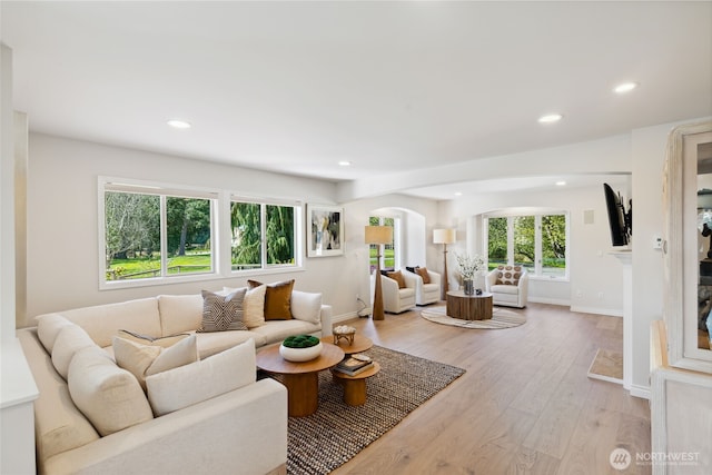 7001 Palm Ln, Anacortes, WA 98221 - living room with recessed lighting, arched walkways, and light wood finished floors