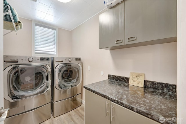 7001 Palm Ln, Anacortes, WA 98221 - laundry room featuring cabinet space, washing machine and dryer, and light wood-style flooring