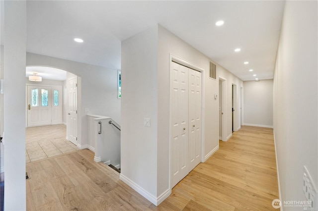 7001 Palm Ln, Anacortes, WA 98221 - hallway with arched walkways, recessed lighting, and light wood-type flooring