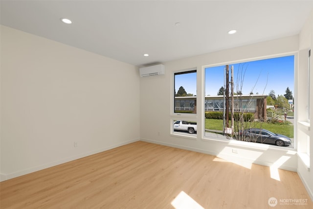 9217B 14th Ave NW, Seattle, WA 98117 - spare room featuring a wall unit AC, wood finished floors, and recessed lighting