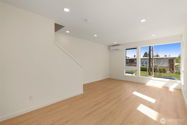 9217B 14th Ave NW, Seattle, WA 98117 - unfurnished room with a wall unit AC, light wood finished floors, recessed lighting, and a smoke detector