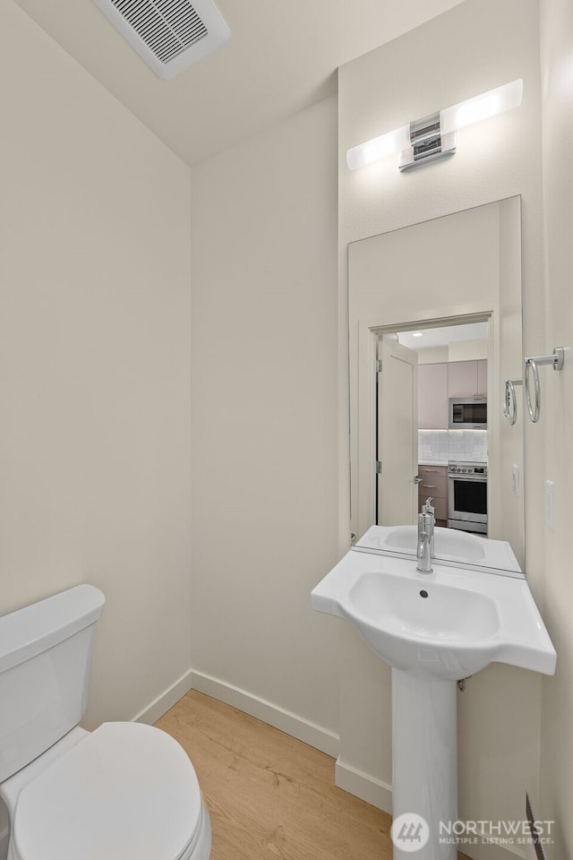9217B 14th Ave NW, Seattle, WA 98117 - half bathroom with toilet and wood finished floors