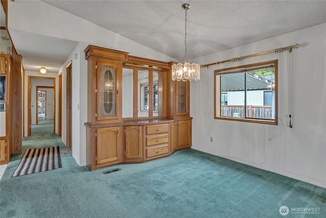 206 Noble Fir Cir, Enumclaw, WA 98022 - unfurnished dining area with a chandelier, light carpet, vaulted ceiling, and a textured ceiling