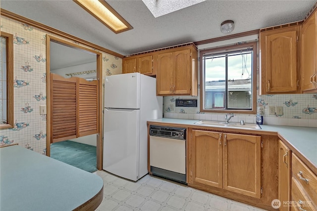 206 Noble Fir Cir, Enumclaw, WA 98022 - kitchen with white appliances, light countertops, light floors, a skylight, and a textured ceiling