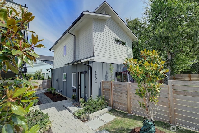 2904 W Bertona St, Seattle, WA 98199 - view of side of property with board and batten siding and a patio