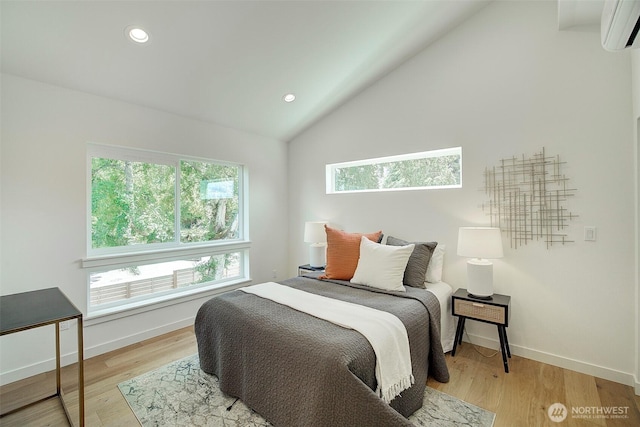 2904 W Bertona St, Seattle, WA 98199 - bedroom featuring a wall mounted AC, light wood finished floors, recessed lighting, and vaulted ceiling