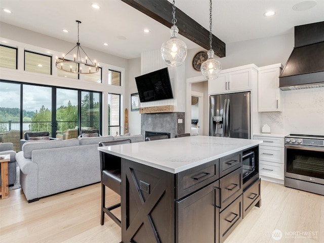 168 Lakeside Dr, Mossyrock, WA 98564 - kitchen with premium range hood, appliances with stainless steel finishes, white cabinets, a fireplace, and open floor plan