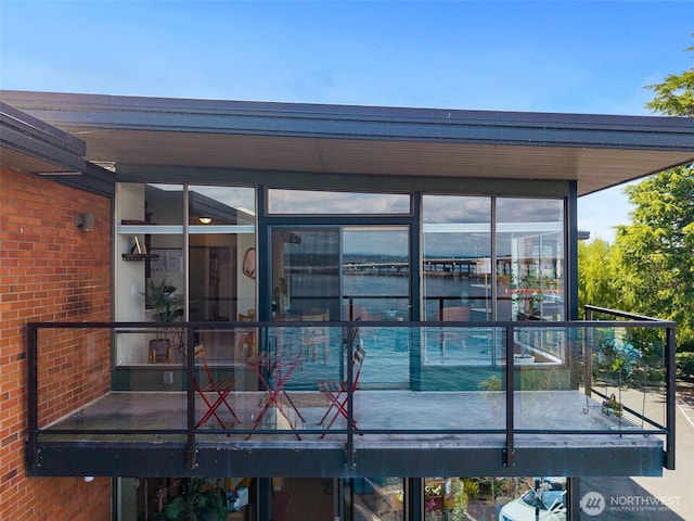 2360 43rd Ave E Unit 404, Seattle, WA 98112 - rear view of property with brick siding and a sunroom
