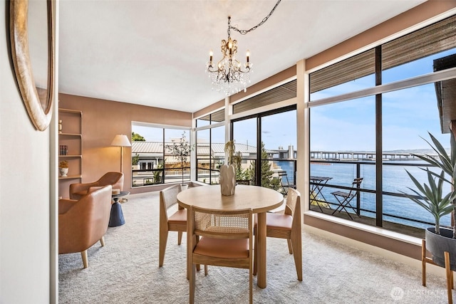 2360 43rd Ave E Unit 404, Seattle, WA 98112 - carpeted dining area featuring a chandelier and a water view