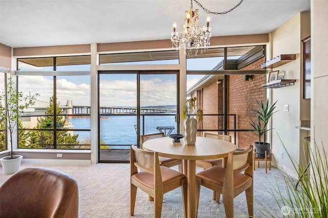 2360 43rd Ave E Unit 404, Seattle, WA 98112 - carpeted dining room featuring a chandelier, plenty of natural light, and a water view