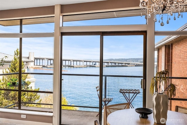 2360 43rd Ave E Unit 404, Seattle, WA 98112 - sunroom / solarium featuring a water view and a chandelier