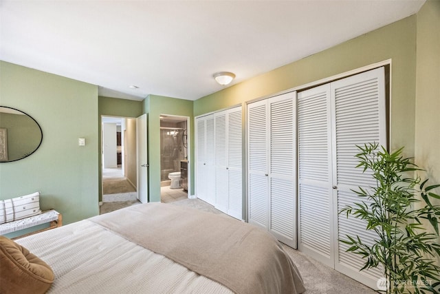 2360 43rd Ave E Unit 404, Seattle, WA 98112 - bedroom with light colored carpet, multiple closets, and ensuite bath