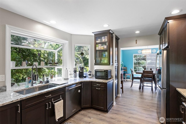 13233 59th Ave W, Edmonds, WA 98026 - kitchen with appliances with stainless steel finishes, dark brown cabinetry, light wood finished floors, plenty of natural light, and recessed lighting