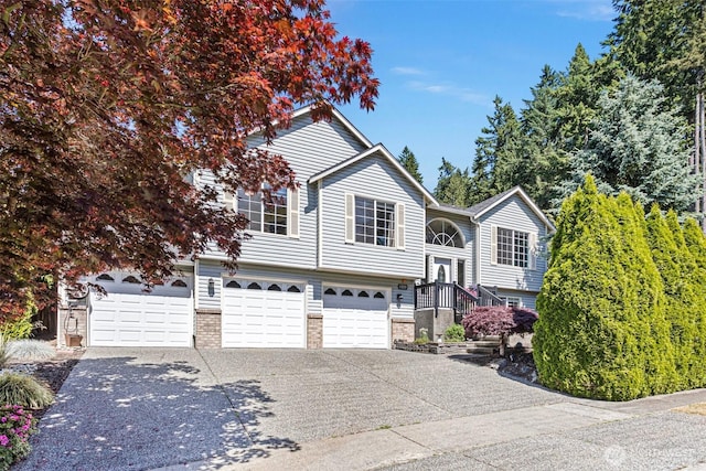 13233 59th Ave W, Edmonds, WA 98026 - raised ranch featuring a garage, concrete driveway, and brick siding