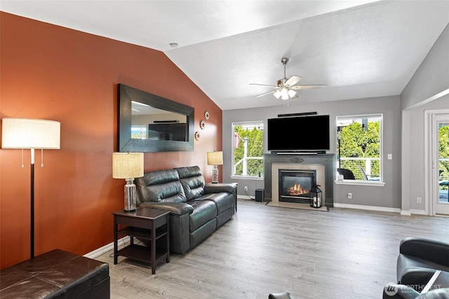 13233 59th Ave W, Edmonds, WA 98026 - living area with lofted ceiling, ceiling fan, wood finished floors, and a glass covered fireplace