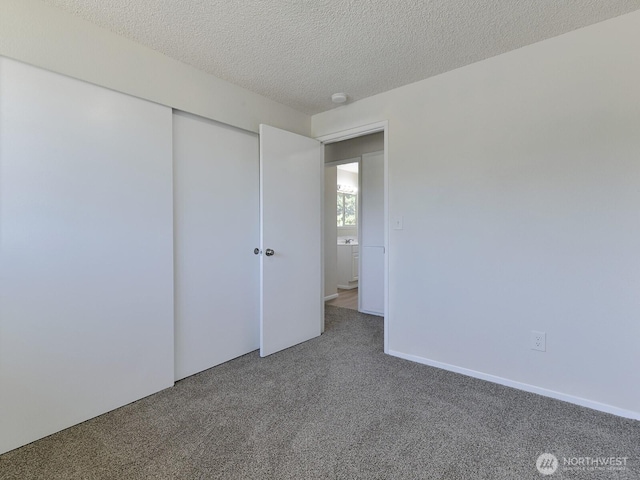 1501 154th St E, Tacoma, WA 98445 - unfurnished bedroom featuring carpet, a textured ceiling, and a closet