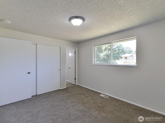 1501 154th St E, Tacoma, WA 98445 - unfurnished bedroom featuring carpet, a closet, and a textured ceiling