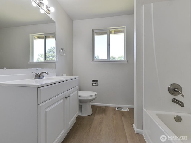 1501 154th St E, Tacoma, WA 98445 - full bath with wood finished floors, vanity, plenty of natural light, and shower / tub combination