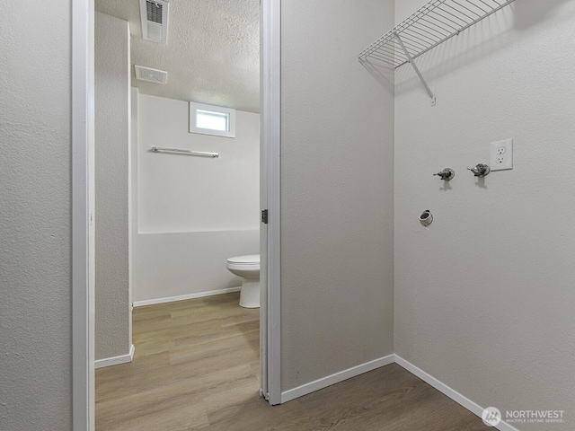 1501 154th St E, Tacoma, WA 98445 - washroom with wood finished floors and baseboards