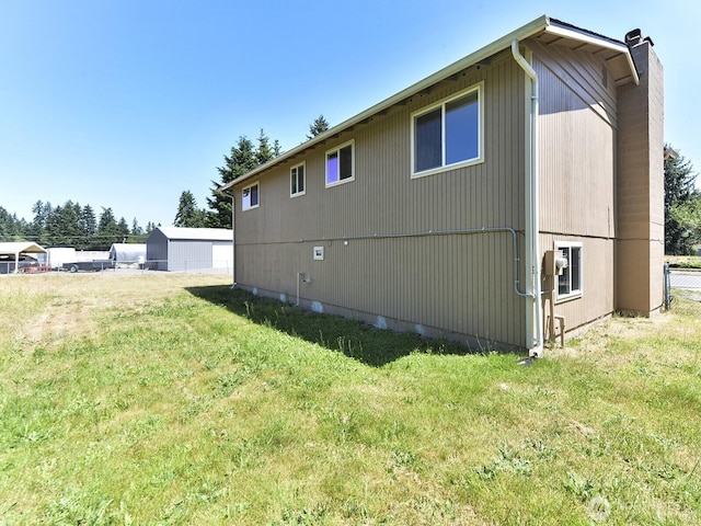 1501 154th St E, Tacoma, WA 98445 - back of house featuring a chimney and a yard