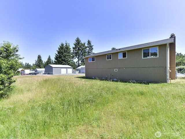 1501 154th St E, Tacoma, WA 98445 - rear view of house featuring a chimney and a garage