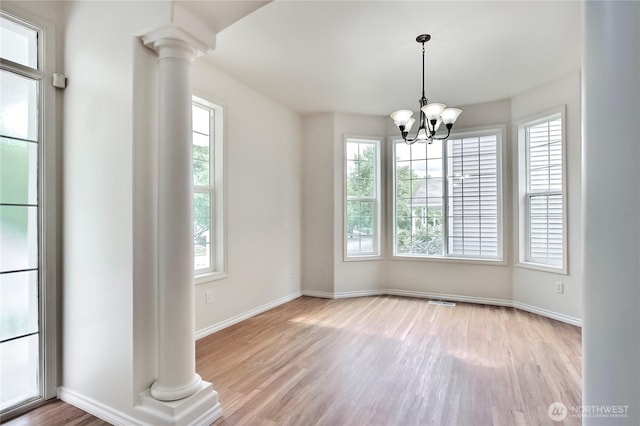 8415 15th Ave SE, Olympia, WA 98513 - empty room with decorative columns, healthy amount of natural light, and wood finished floors