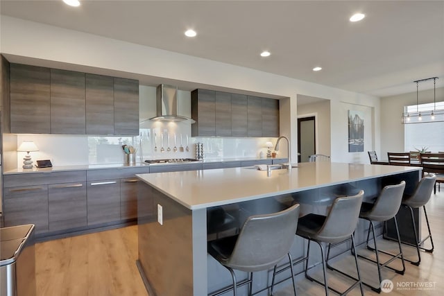 4615 SW Olivine Dr SW, Port Orchard, WA 98367 - kitchen with wall chimney range hood, modern cabinets, gray cabinets, stainless steel gas cooktop, and recessed lighting
