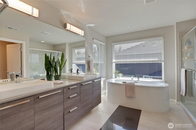 4615 SW Olivine Dr SW, Port Orchard, WA 98367 - full bath with tile patterned floors, a stall shower, double vanity, and a bath