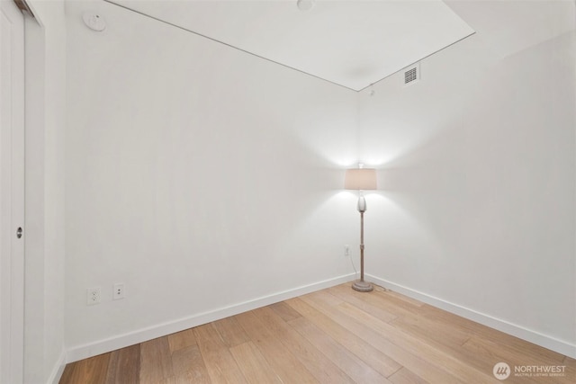 450 S Main St Unit 505, Seattle, WA 98101 - unfurnished room with baseboards and light wood-style flooring