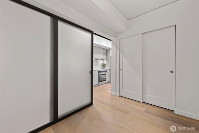 450 S Main St Unit 505, Seattle, WA 98101 - unfurnished bedroom featuring light wood finished floors and a closet