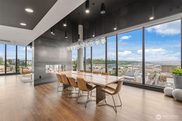 450 S Main St Unit 505, Seattle, WA 98101 - dining space with a wall of windows, wood finished floors, and a city view