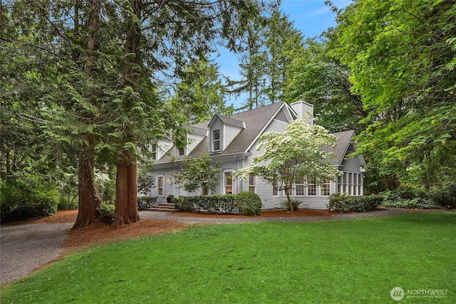 7089 NE Bay Hill Rd, Bainbridge Island, WA 98110 - cape cod house with a front lawn, a chimney, and roof with shingles
