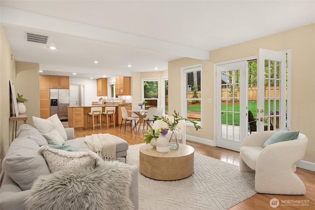 7089 NE Bay Hill Rd, Bainbridge Island, WA 98110 - living area featuring light wood finished floors, french doors, and recessed lighting