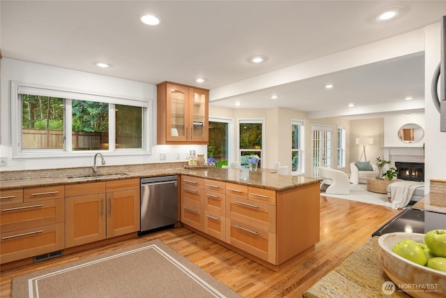 7089 NE Bay Hill Rd, Bainbridge Island, WA 98110 - kitchen featuring stainless steel dishwasher, a peninsula, light wood-type flooring, light stone counters, and recessed lighting