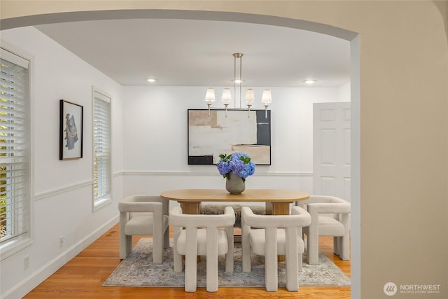 7089 NE Bay Hill Rd, Bainbridge Island, WA 98110 - dining room with light wood-style floors, arched walkways, a chandelier, and recessed lighting