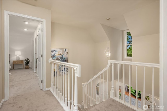 7089 NE Bay Hill Rd, Bainbridge Island, WA 98110 - corridor featuring an upstairs landing, carpet, and vaulted ceiling