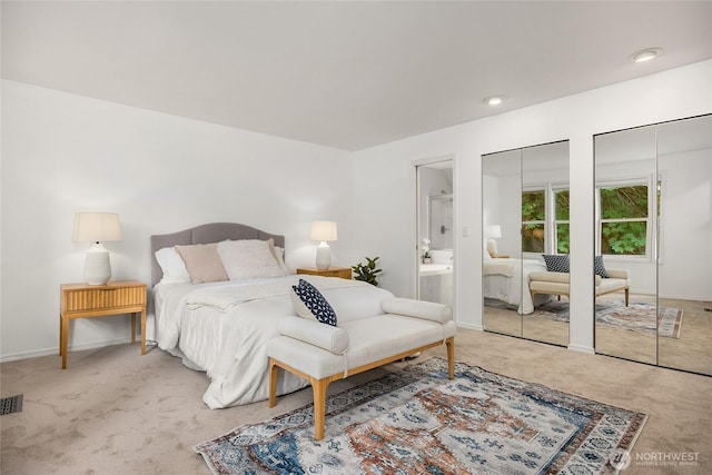 7089 NE Bay Hill Rd, Bainbridge Island, WA 98110 - carpeted bedroom featuring multiple closets and ensuite bath