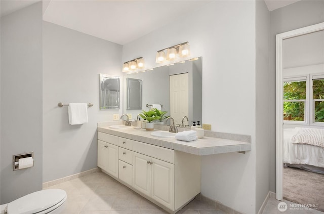 7089 NE Bay Hill Rd, Bainbridge Island, WA 98110 - ensuite bathroom featuring double vanity and tile patterned flooring