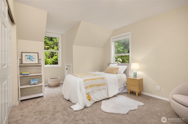 7089 NE Bay Hill Rd, Bainbridge Island, WA 98110 - carpeted bedroom featuring baseboards and lofted ceiling