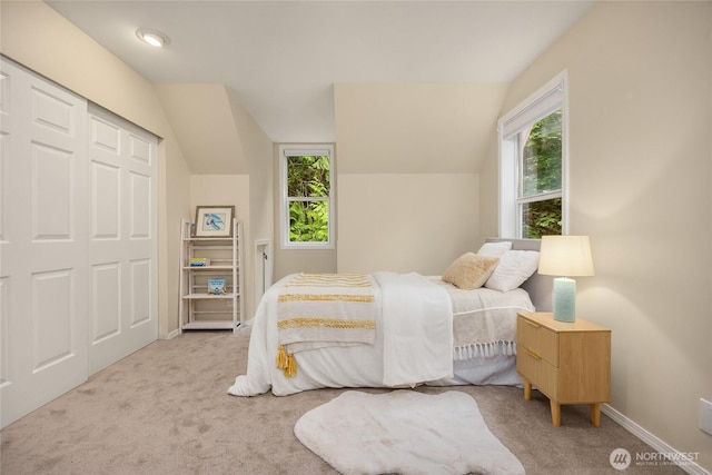 7089 NE Bay Hill Rd, Bainbridge Island, WA 98110 - carpeted bedroom featuring vaulted ceiling and a closet
