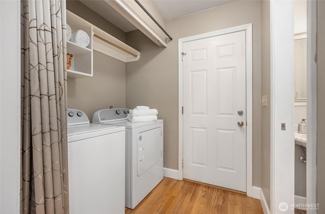 7089 NE Bay Hill Rd, Bainbridge Island, WA 98110 - laundry room with washer and clothes dryer and light wood finished floors