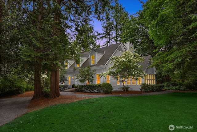7089 NE Bay Hill Rd, Bainbridge Island, WA 98110 - cape cod home featuring a front lawn and a chimney