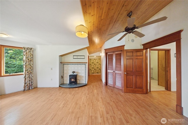7554 Guemes Island Rd, Anacortes, WA 98221 - unfurnished living room featuring a wood stove, ceiling fan, wood finished floors, and vaulted ceiling