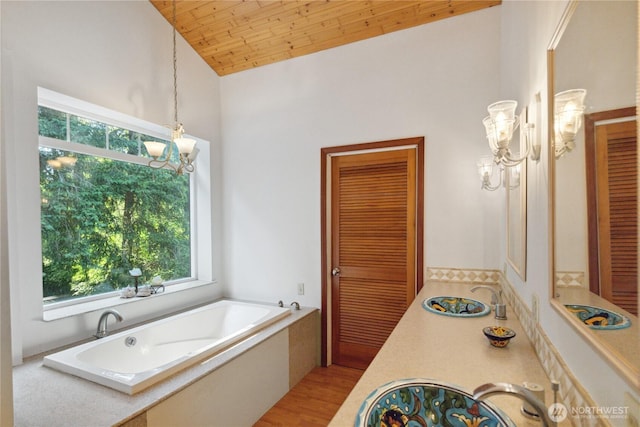 7554 Guemes Island Rd, Anacortes, WA 98221 - full bath featuring plenty of natural light, a garden tub, high vaulted ceiling, wood finished floors, and vanity