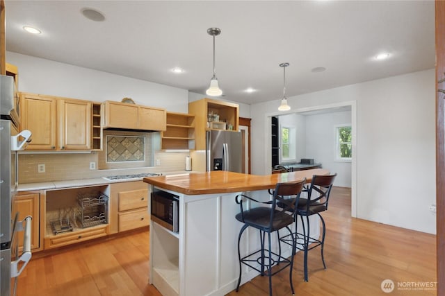 7554 Guemes Island Rd, Anacortes, WA 98221 - kitchen with open shelves, appliances with stainless steel finishes, backsplash, light brown cabinets, and light wood-style flooring