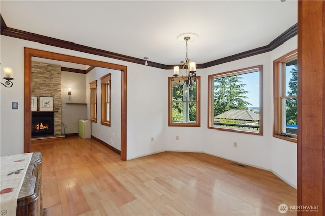 7554 Guemes Island Rd, Anacortes, WA 98221 - unfurnished dining area with light wood finished floors, ornamental molding, a chandelier, a fireplace, and radiator