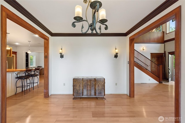 7554 Guemes Island Rd, Anacortes, WA 98221 - spare room with a chandelier, wood finished floors, crown molding, and stairs