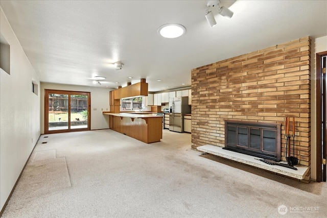 15023 Densmore Ave N, Shoreline, WA 98133 - unfurnished living room with a brick fireplace and light carpet