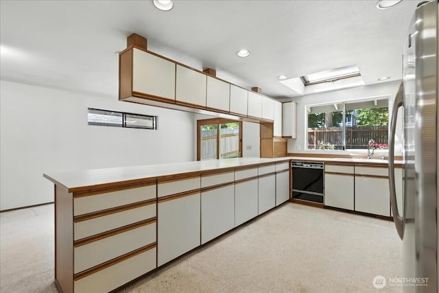 15023 Densmore Ave N, Shoreline, WA 98133 - kitchen featuring black dishwasher, stainless steel fridge, light colored carpet, plenty of natural light, and recessed lighting