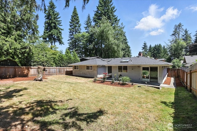 15023 Densmore Ave N, Shoreline, WA 98133 - back of house featuring a fenced backyard and a chimney